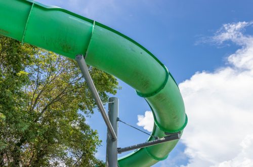 Green waterslide in the air on a sunny day