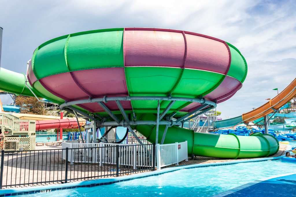 Green and pink water park ride with slides coming out