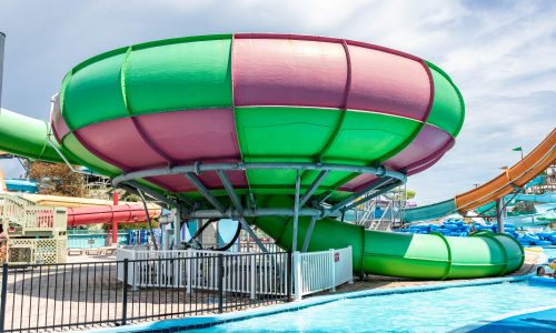 Green and pink water park ride with slides coming out