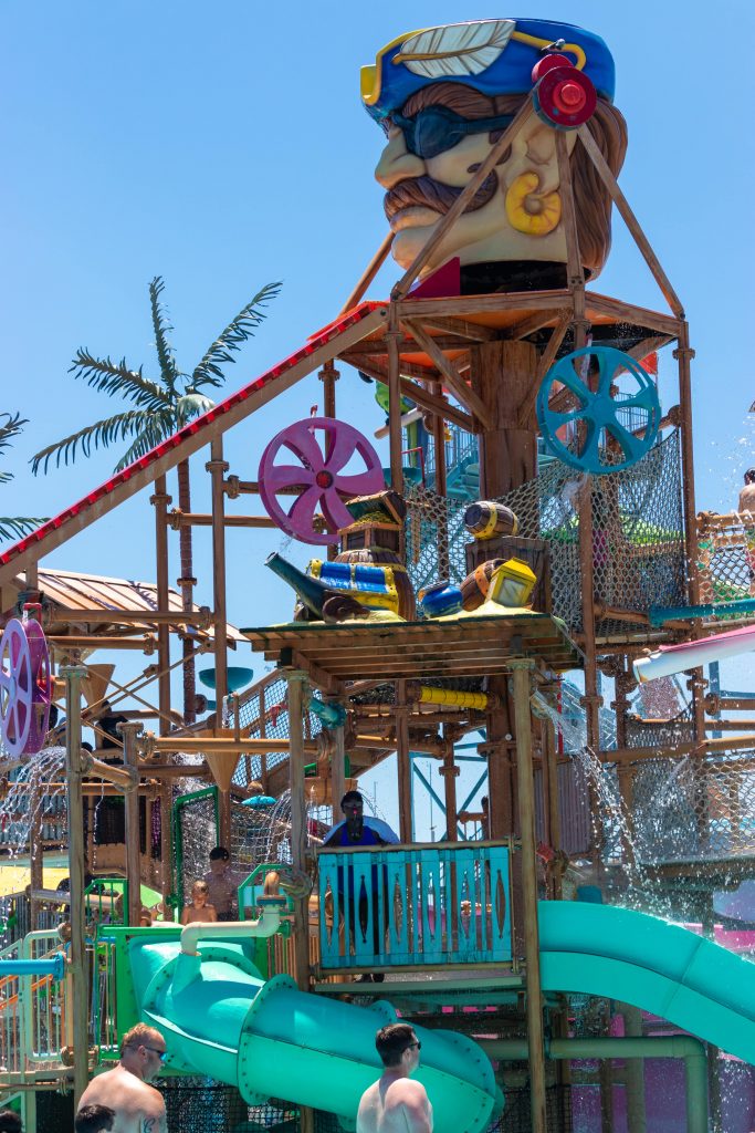 Elevated wooden playground with giant pirate head full of water