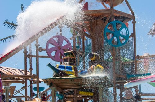 Giant bucket with pirate face dumping water on ride